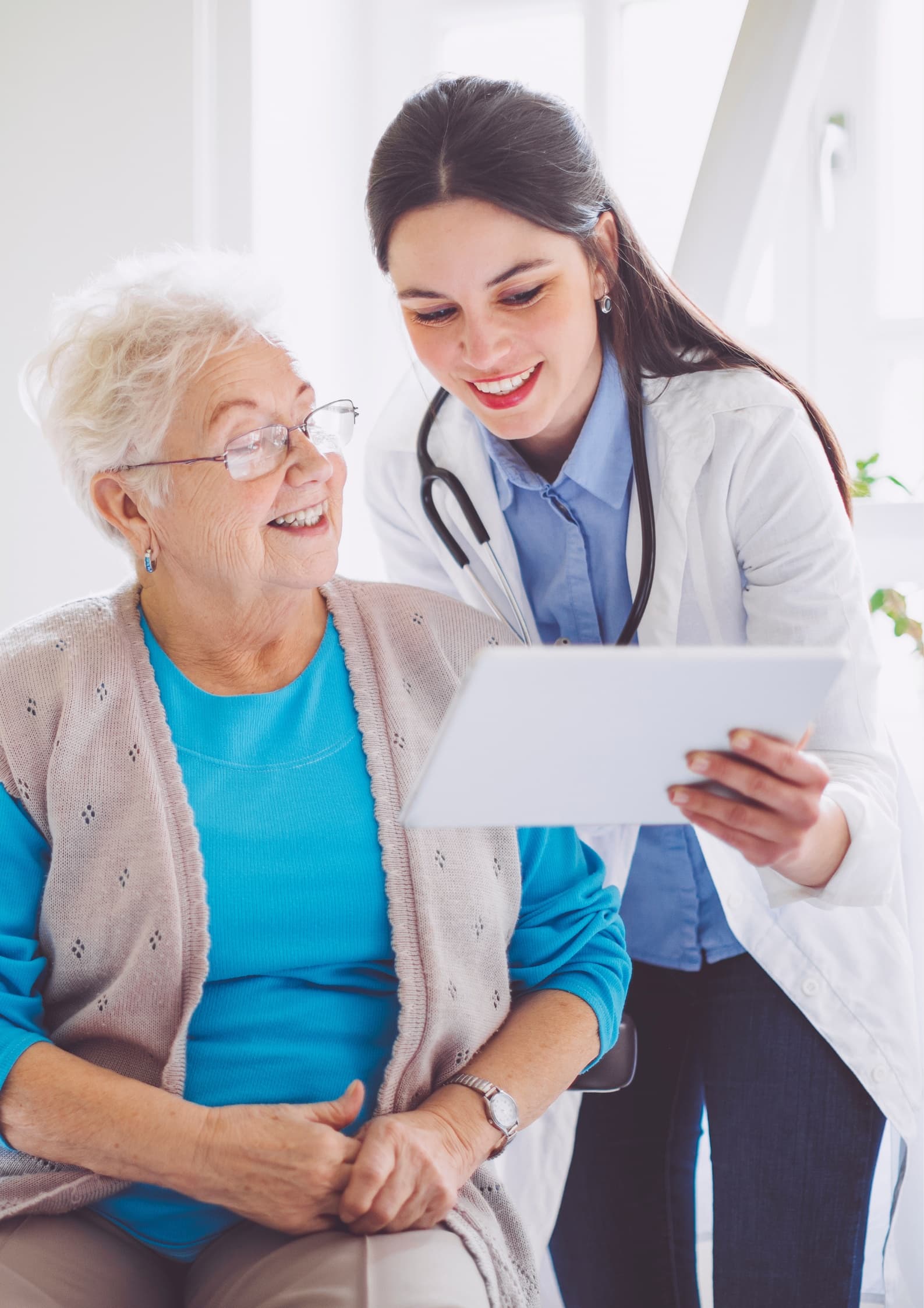Optometrist assisting an elderly patient with new glasses